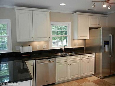 Kitchen. Remodeled kitchen with travertine tile flooring, new cabinets, granite counters, Stainless appliances and new lighting.