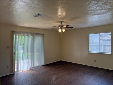 Empty room with dark wood-style flooring, ceiling