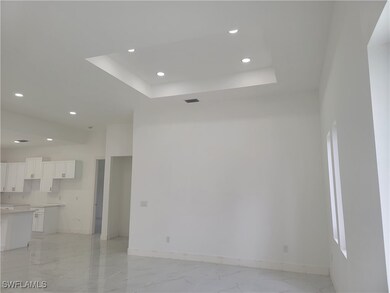 Unfurnished living room featuring light marble fin