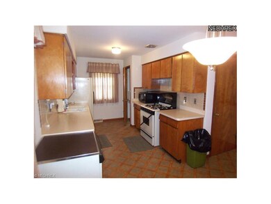 Additional cabinet space on the opposite wall give