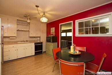 Kitchen is large enough for a small table for casu