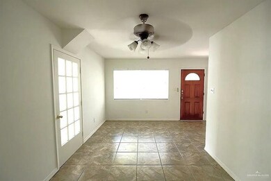 Entryway with a ceiling fan and baseboards