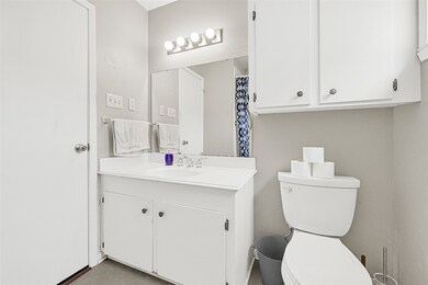 Full bathroom with vanity storage and modern fixtures.