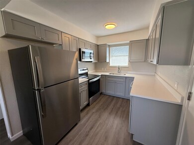 Kitchen featuring dark wood finished floors, gray