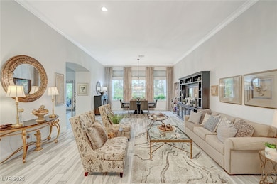 Living room featuring arched walkways, ornamental