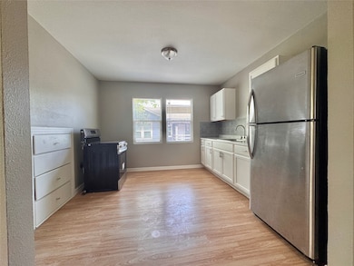 Spacious kitchen with refrigerator and electric st