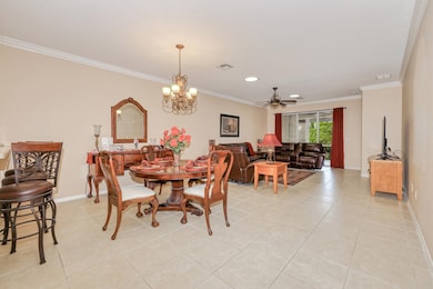 Dining room featuring crown molding, light tile patterned floors, a chandelier, ceiling fan, and recessed lighting