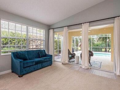Living room with sliders opening to the covered la