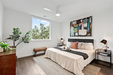 Bedroom with ceiling fan, baseboards, visible ven