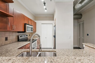 Kitchen with light stone countertops, appliances w