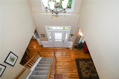 Foyer with wood floors and cathedral ceiling