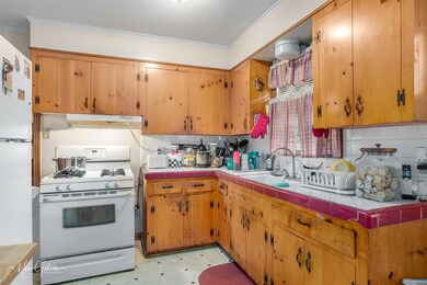 Kitchen with tasteful backsplash, white appliances