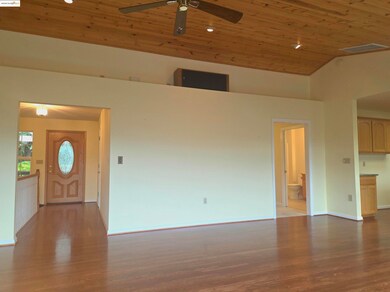 Entryway inside over refinisged oak floors, wood ceiling, recessed lighting, high vaulted ceiling, and ceiling fan