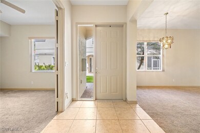 Bright entry with new carpet in the den and living