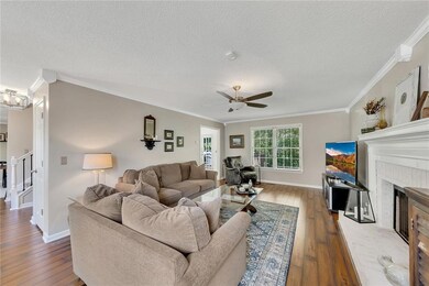 Large windows, neutral tones, and open layout make this living area feel bright and welcoming.