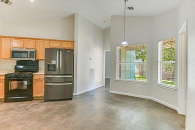 Kitchen with stainless steel appliances, high vau