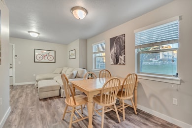 Dining area featuring light wood finished floors and a textured ceiling