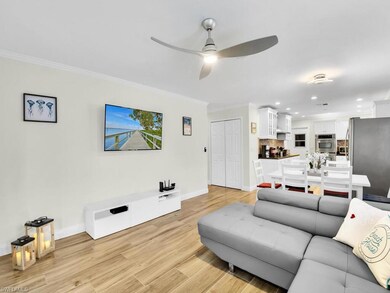 Living area with light wood-style floors, recessed lighting, ornamental molding, and ceiling fan