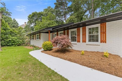 View of front facade with brick siding and a front lawn