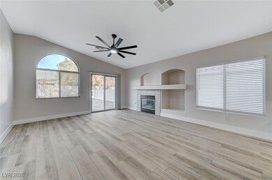 Unfurnished living room featuring ceiling fan, lig