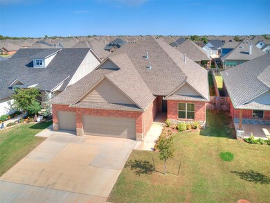 View of front facade with a garage, a shingled roof, a residential view, and brick siding