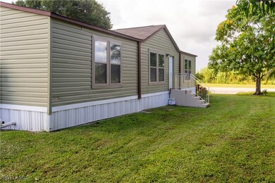 View of side of home with a lawn