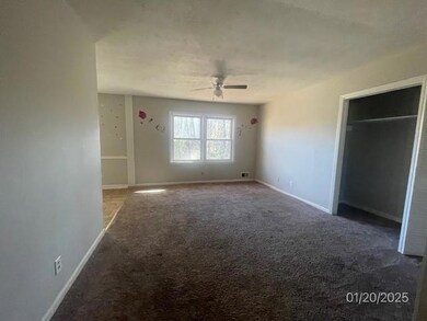 Unfurnished bedroom with carpet and a ceiling fan