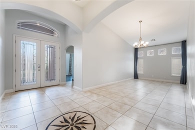 Foyer featuring a chandelier, light tile patterned