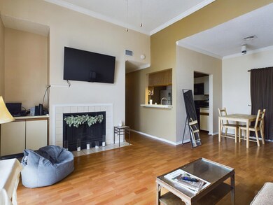 Living area with crown molding, wood finished flo