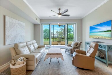 Living room with ornamental molding, ceiling fan, baseboards, and wood finished floors