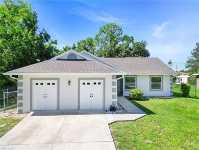 Ranch-style home featuring a front lawn