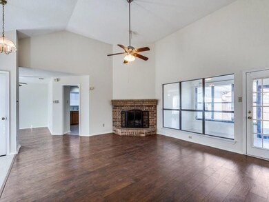 Unfurnished living room featuring a brick fireplac