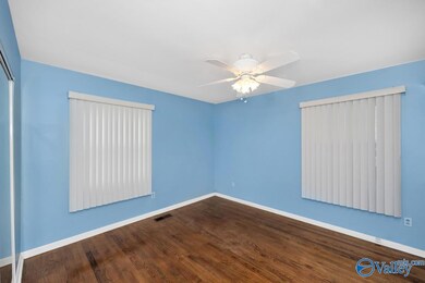 Wood Flooring, ceiling fan, vertical blinds