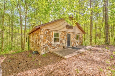 View of outbuilding featuring a view of trees