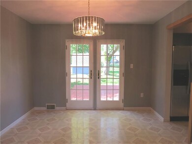 The spacious dining area features french doors tha