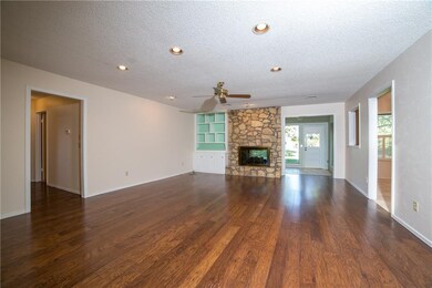 Living Room with engineered hardwood floors, rock 