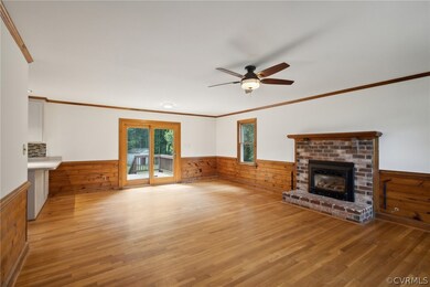 Unfurnished living room featuring crown molding, a