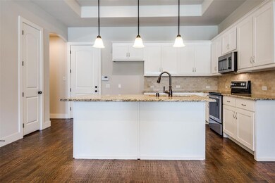 Stand alone kitchen island, granite counter tops, pantry, and ample cabinetry are provided.