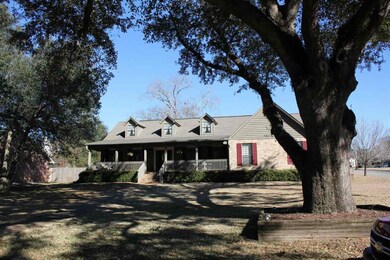 Front of home with trees and patio
