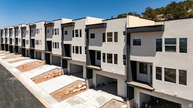 View of property featuring a residential view, driveway, and a garage