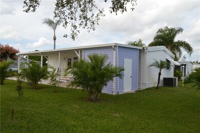 SIDE VIEW OF CARPORT & 8X8 SHED AND BACK OF HOME.