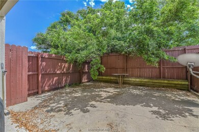 Fenced back patio outside kitchen door