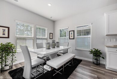 Dining space featuring healthy amount of natural light, baseboards, dark wood-style flooring, and recessed lighting