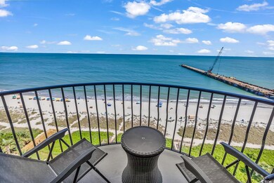 Balcony with view of water and beach