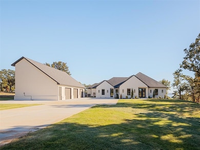 View of front of house with a front lawn and a gar
