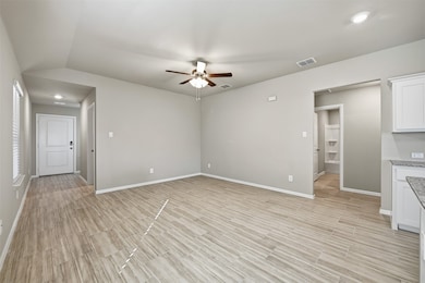 Unfurnished living room with ceiling fan, wood tiled floors, and recessed lighting