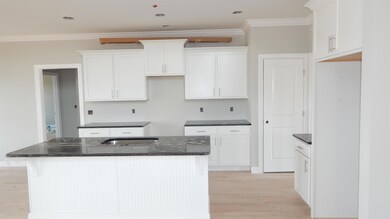 All white kitchen with plenty of work space & storage.  Pics are from a previously built home 