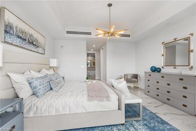 Bedroom featuring ceiling fan and a tray ceiling