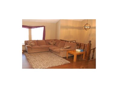 Relax in the living room featuring a vaulted ceili