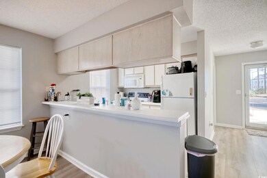 Kitchen with kitchen peninsula, light hardwood / w